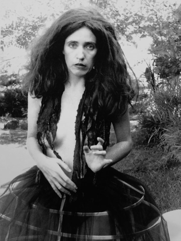 Aimee Greenberg as Lilith standing in hoop skirt with seaweed around her neck for Dark Moon of Lilith promo.